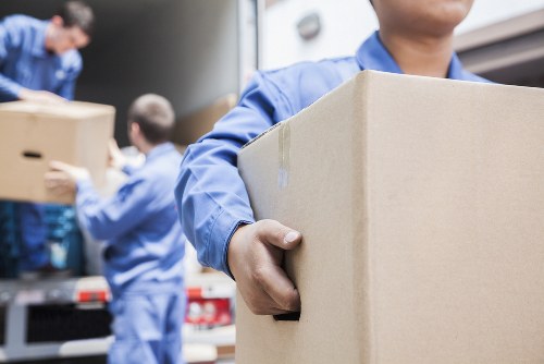 Furniture being carefully carried down stairs in a London flat move