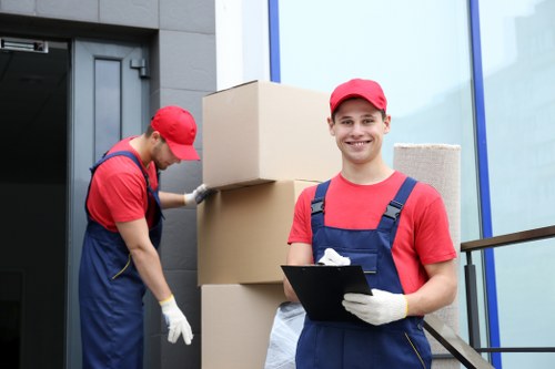 Local movers handling furniture and boxes in a Soho residential building