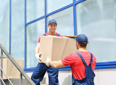 Furniture removals team planning a move in a busy Soho street