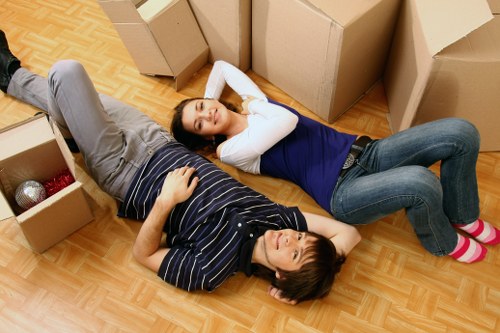 Packed household boxes and furniture prepared for a Soho flat relocation